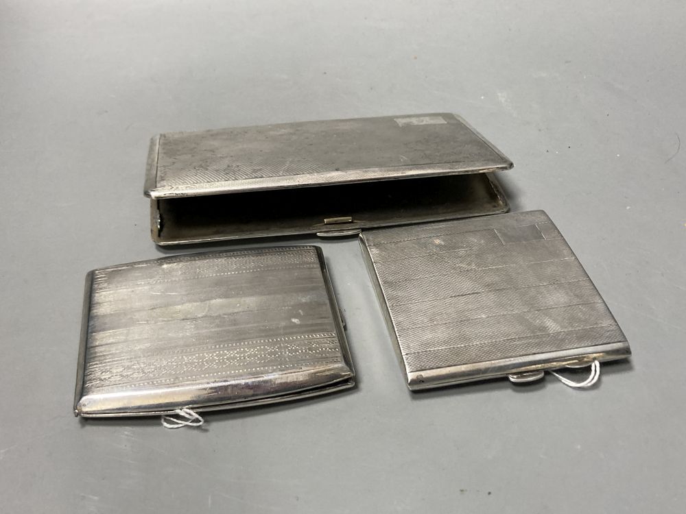 Three engine-turned silver cigarette cases, various,